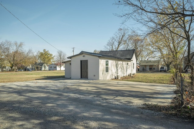 view of property exterior with a yard