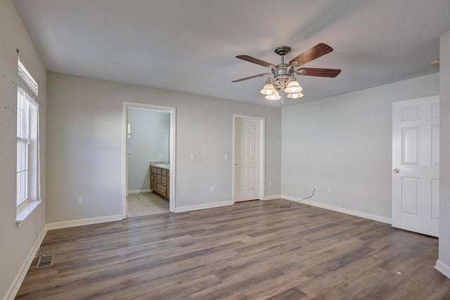 unfurnished bedroom featuring ceiling fan, light hardwood / wood-style floors, and ensuite bath