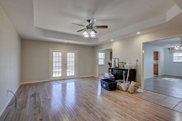 living room with french doors, light wood-type flooring, and plenty of natural light