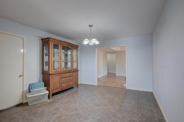 dining room featuring light tile patterned floors and an inviting chandelier