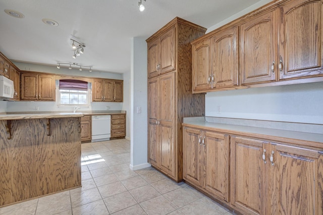 kitchen featuring white appliances and light tile patterned floors