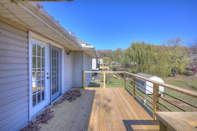 wooden deck with a lawn