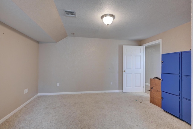 bonus room featuring light carpet, a textured ceiling, and lofted ceiling