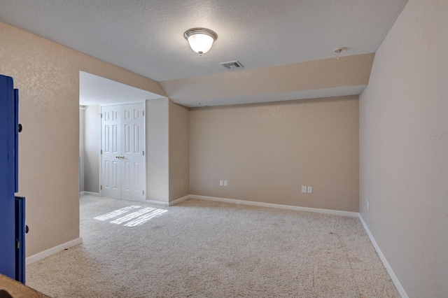 spare room with carpet floors and a textured ceiling