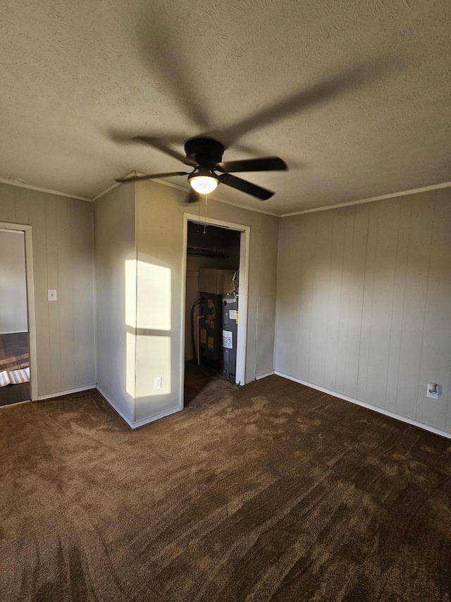 unfurnished bedroom with ceiling fan, dark carpet, and a textured ceiling