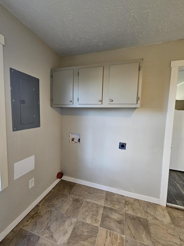 clothes washing area featuring cabinets, washer hookup, hookup for an electric dryer, electric panel, and a textured ceiling