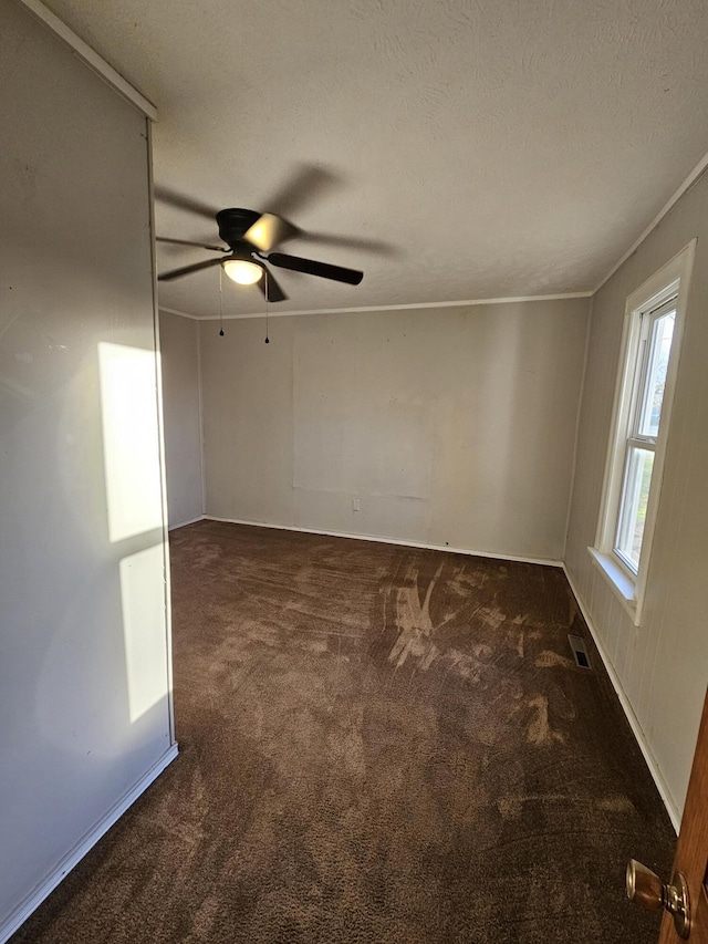 unfurnished room with dark colored carpet, a textured ceiling, and ceiling fan