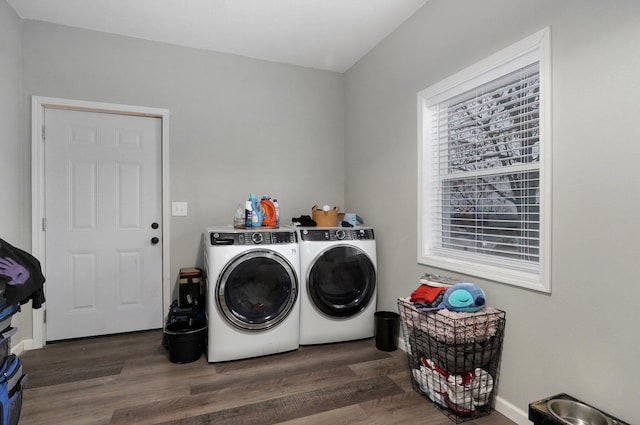 washroom with washer and clothes dryer and dark hardwood / wood-style flooring