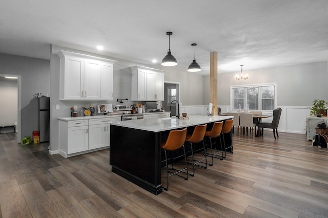 kitchen featuring white cabinets, dark hardwood / wood-style floors, and appliances with stainless steel finishes