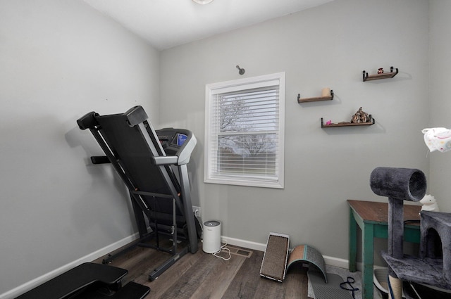 workout area with dark wood-type flooring