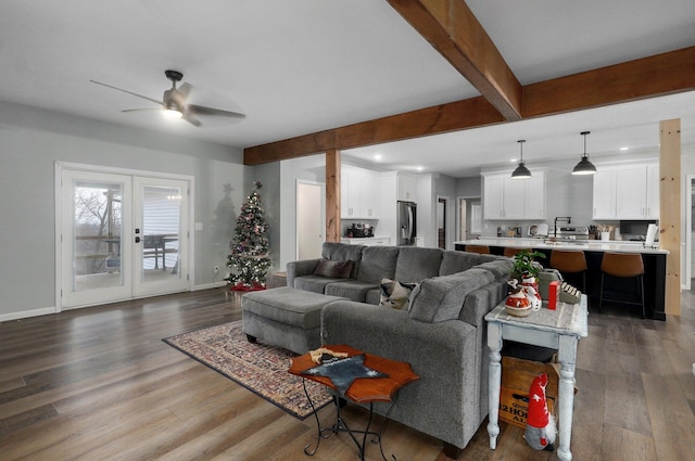 living room with beam ceiling, ceiling fan, french doors, and dark wood-type flooring