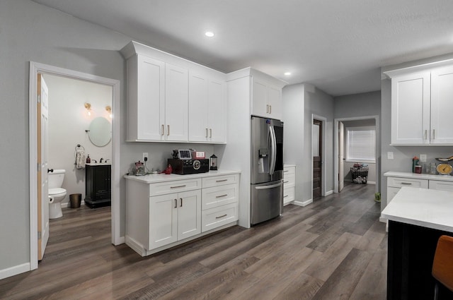 kitchen with white cabinets, stainless steel refrigerator with ice dispenser, and dark hardwood / wood-style flooring