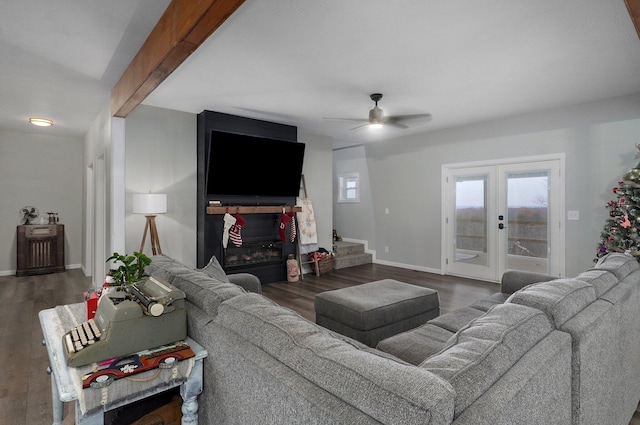 living room featuring dark hardwood / wood-style floors, beam ceiling, ceiling fan, and french doors