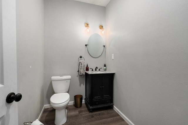 bathroom featuring hardwood / wood-style floors, vanity, and toilet