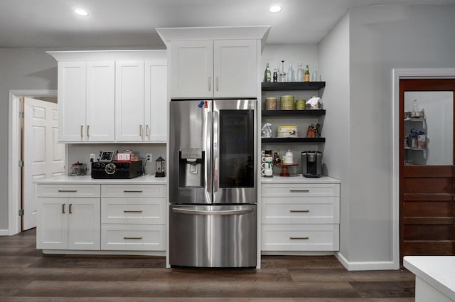 kitchen with white cabinets, dark hardwood / wood-style floors, and stainless steel refrigerator with ice dispenser