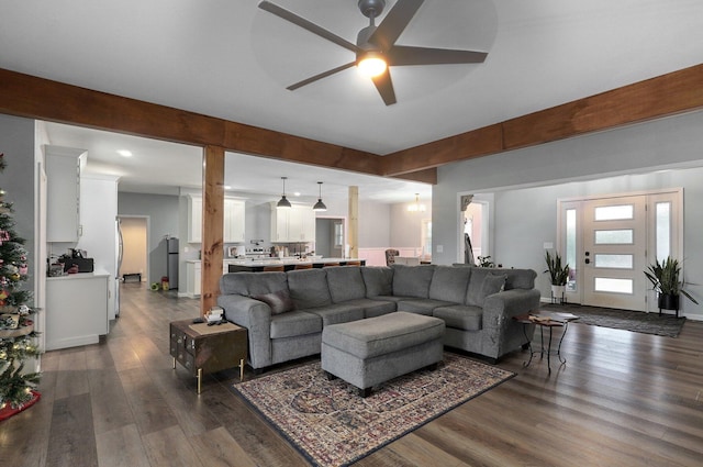 living room featuring ceiling fan and dark wood-type flooring