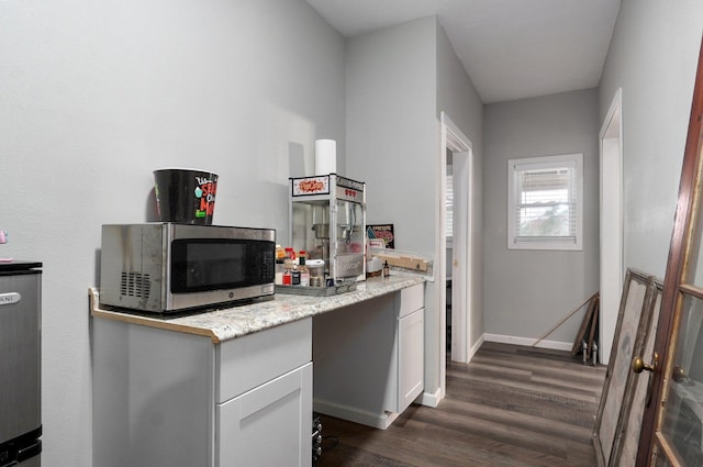 kitchen featuring dark hardwood / wood-style floors and white cabinetry