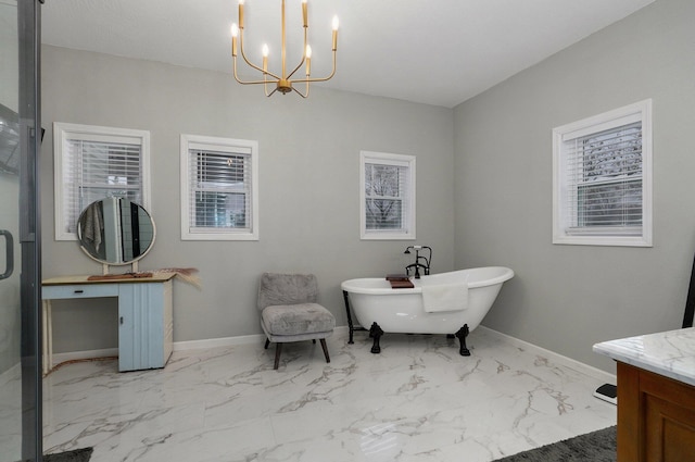 bathroom featuring a tub to relax in, vanity, and a notable chandelier