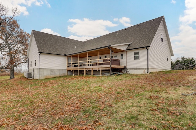 rear view of house featuring a wooden deck, a yard, and central AC unit