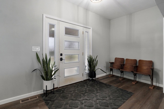 entrance foyer with dark hardwood / wood-style floors