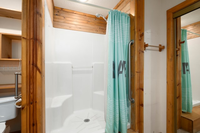 bathroom featuring curtained shower and toilet