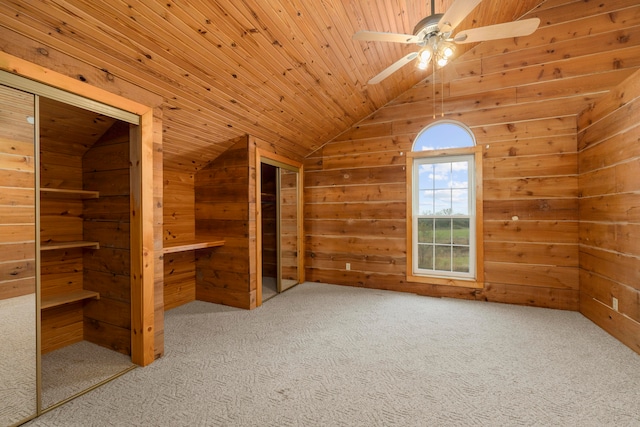 bonus room with carpet, ceiling fan, wooden walls, and wood ceiling