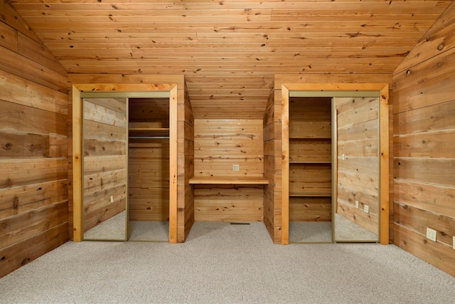 unfurnished bedroom with wooden walls and vaulted ceiling