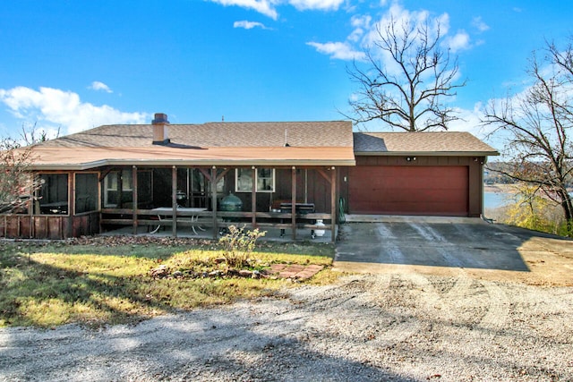 view of front facade featuring a sunroom and a garage