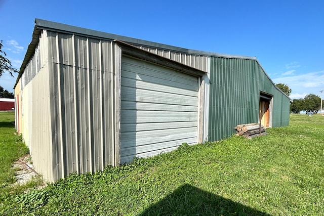 view of outbuilding with a yard