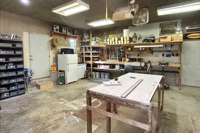 miscellaneous room featuring a workshop area and concrete floors