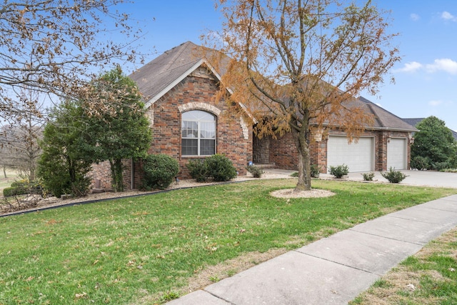 view of front of property with a garage and a front yard