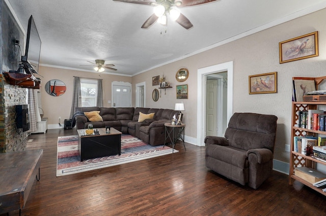 living room featuring a textured ceiling, ceiling fan, ornamental molding, and dark wood-type flooring