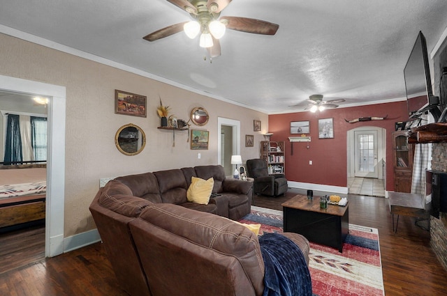 living room with a textured ceiling, crown molding, ceiling fan, and dark hardwood / wood-style floors