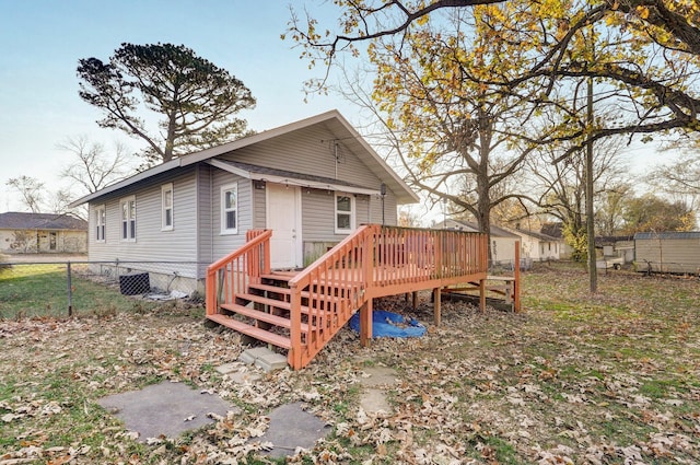 rear view of property featuring a wooden deck