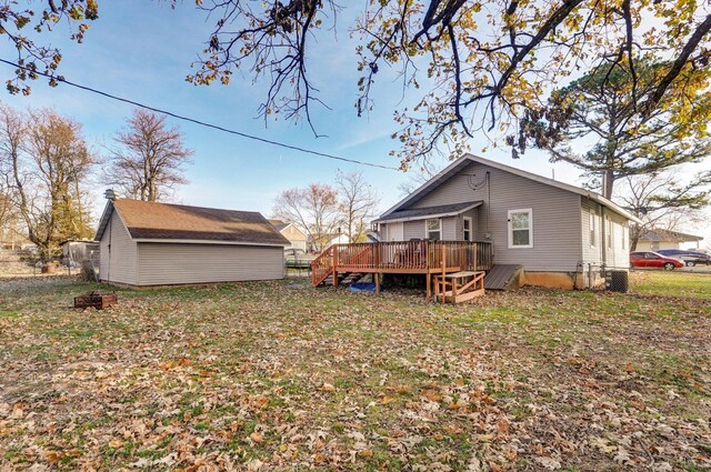 rear view of house featuring a deck and central AC