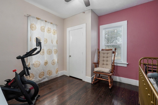 workout room featuring ceiling fan and dark hardwood / wood-style floors