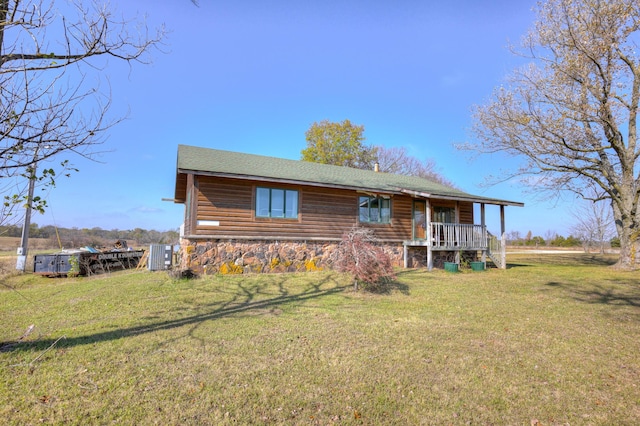 cabin featuring a porch and a front lawn