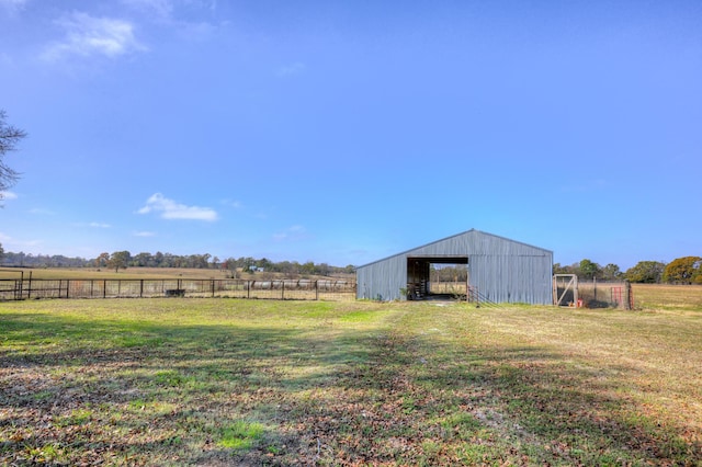 view of yard with a rural view and an outdoor structure