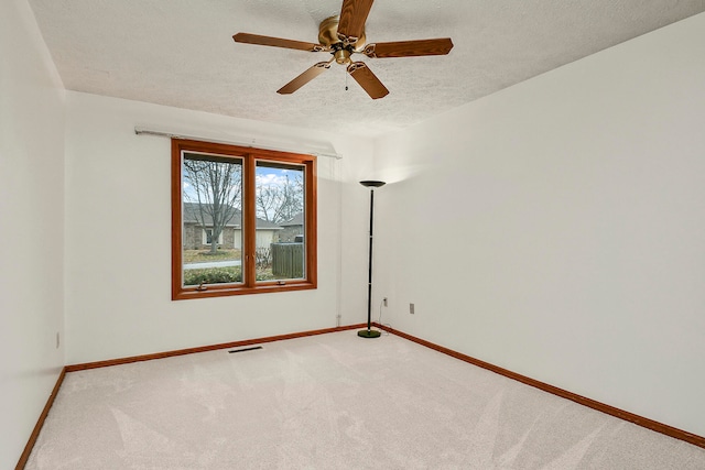 carpeted empty room with a textured ceiling and ceiling fan