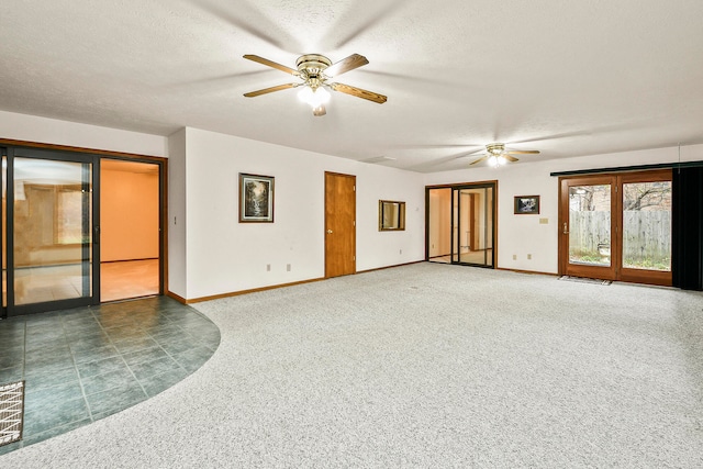 carpeted empty room featuring ceiling fan and a textured ceiling