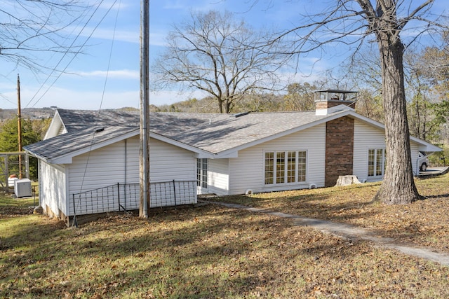 364 W Rd, Branson, MO 65616 - view of home's exterior featuring roof with shingles and a chimney