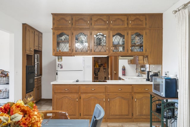 364 W Rd, Branson, MO 65616 - kitchen with brown cabinetry, oven, light countertops, and light tile patterned flooring