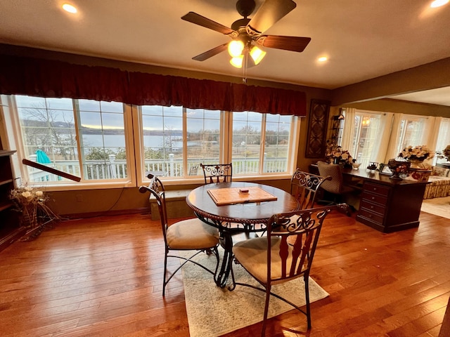 dining room with ceiling fan and light wood-type flooring