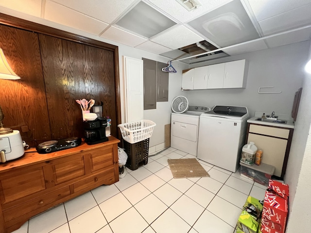 laundry room with washer and dryer, light tile patterned flooring, cabinets, and sink