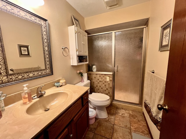 bathroom with walk in shower, tile patterned floors, a textured ceiling, toilet, and vanity