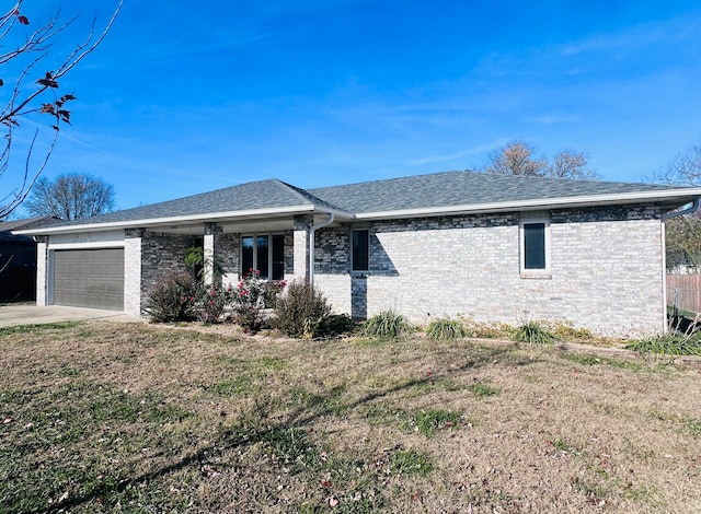 single story home featuring a garage and a front lawn