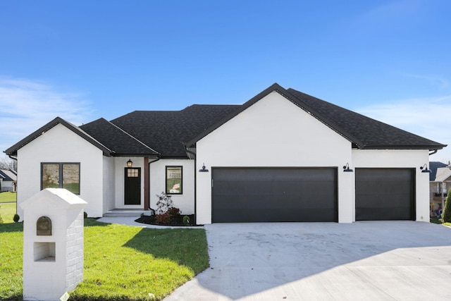 view of front of property with a garage and a front lawn