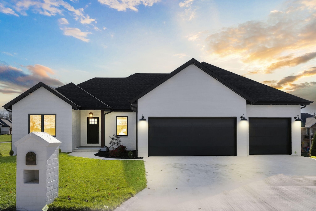 view of front of house with a garage and a yard