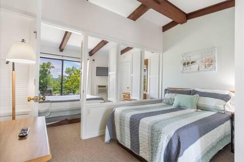 carpeted bedroom with beam ceiling