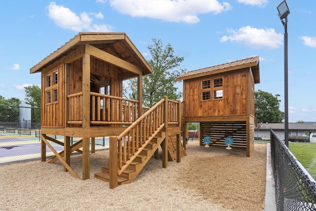 view of jungle gym with tennis court